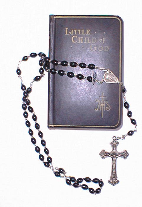 A child's prayer book and rosary set